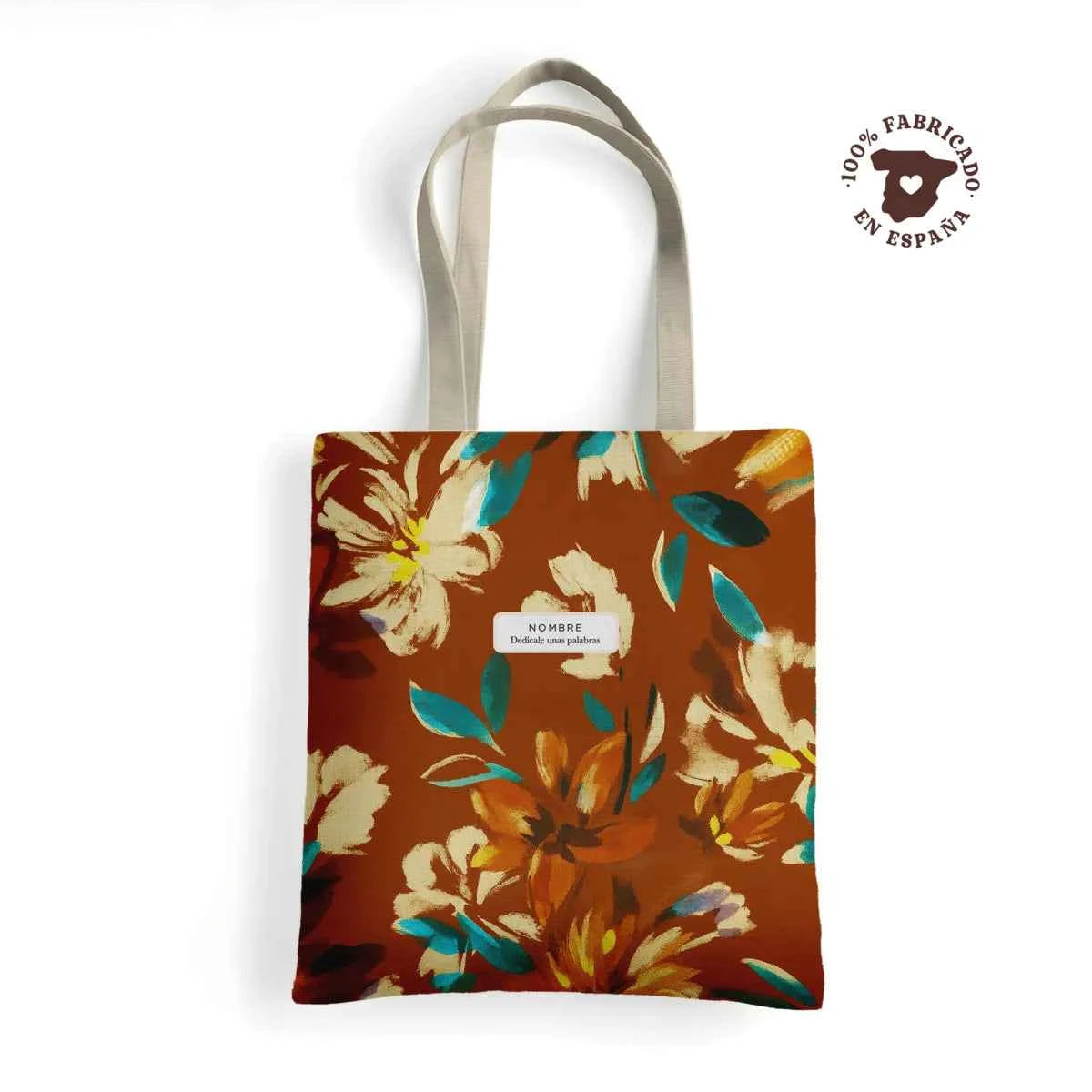 Tote bag de loneta fabricada en España con estampado floral otoñal en tonos marrones y verdes, personalizada con nombre y frase. Regalo ideal para mujer.