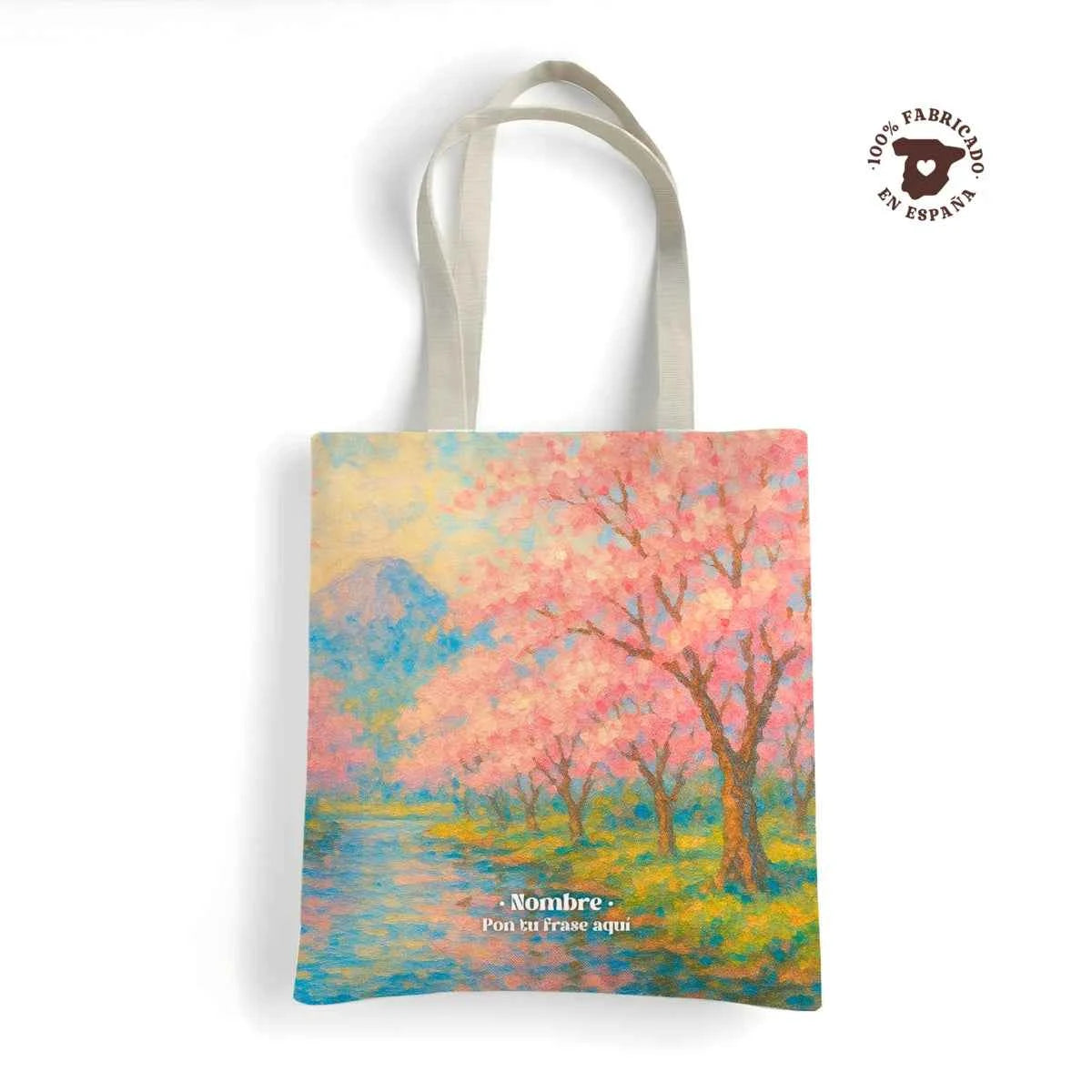 Tote bag resistente 100% hecha en España con estampado Cerezos en tonos rosa pastel y azul cielo. Personalizable con nombre.