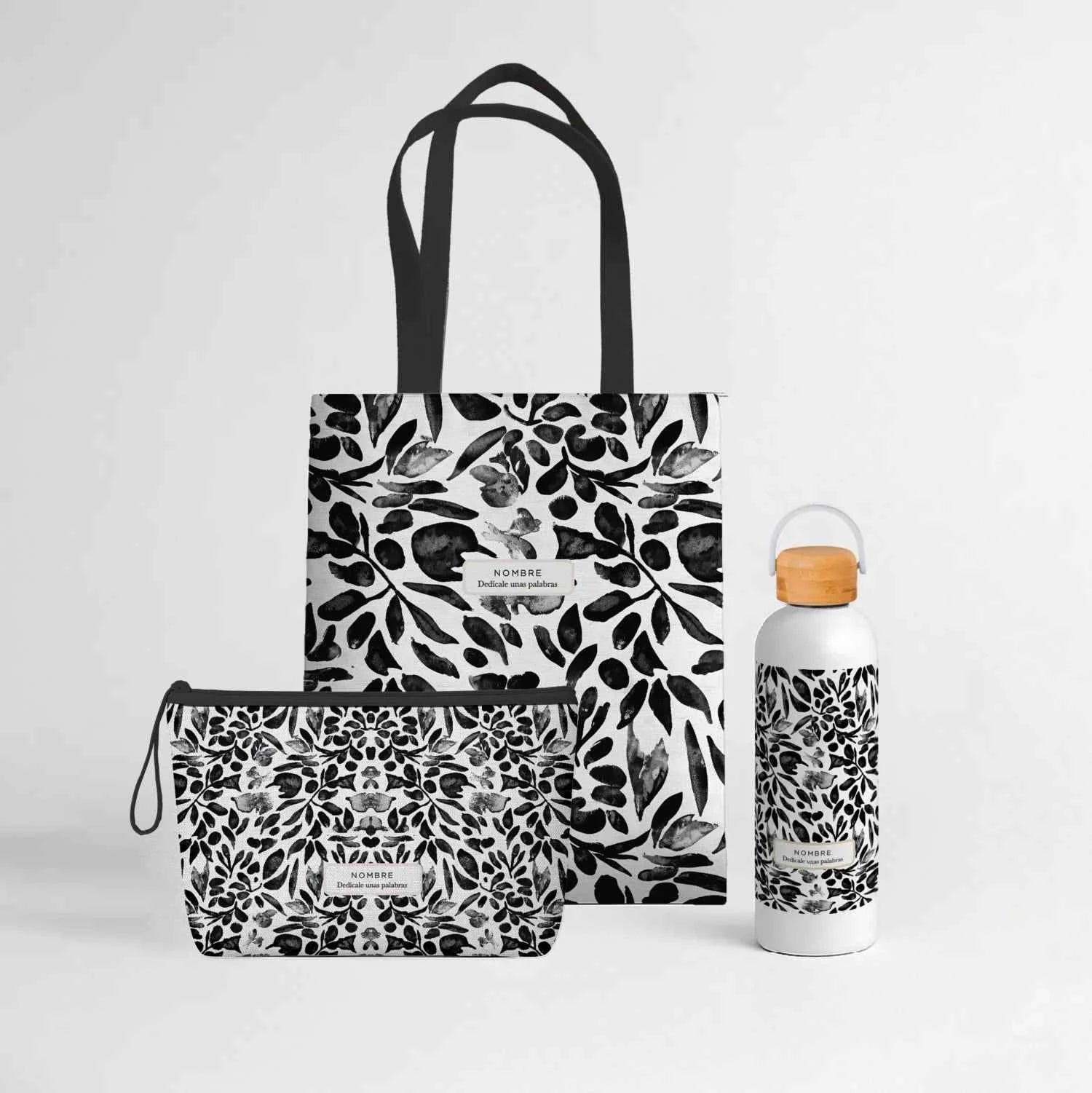 Wonder Pack Flores Negras personalizado con tote bag de loneta, neceser y bidón térmico de 500 ml, todos con estampado floral en negro y gris acuarela.